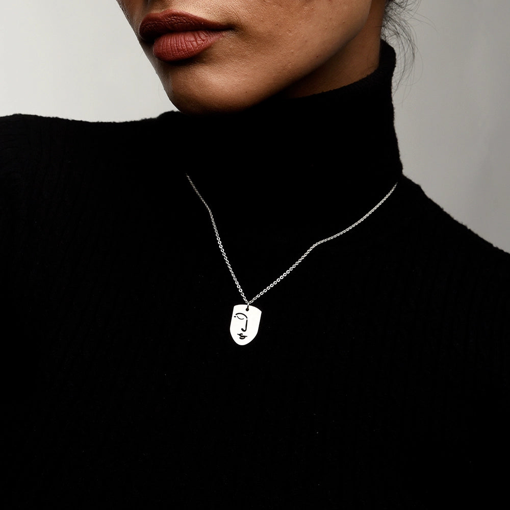 Elevate your style with the Silent Face Necklace. Featuring a sleek, minimalist face pendant, this premium necklace adds a touch of modern elegance to any look. Perfect for everyday wear or special occasions