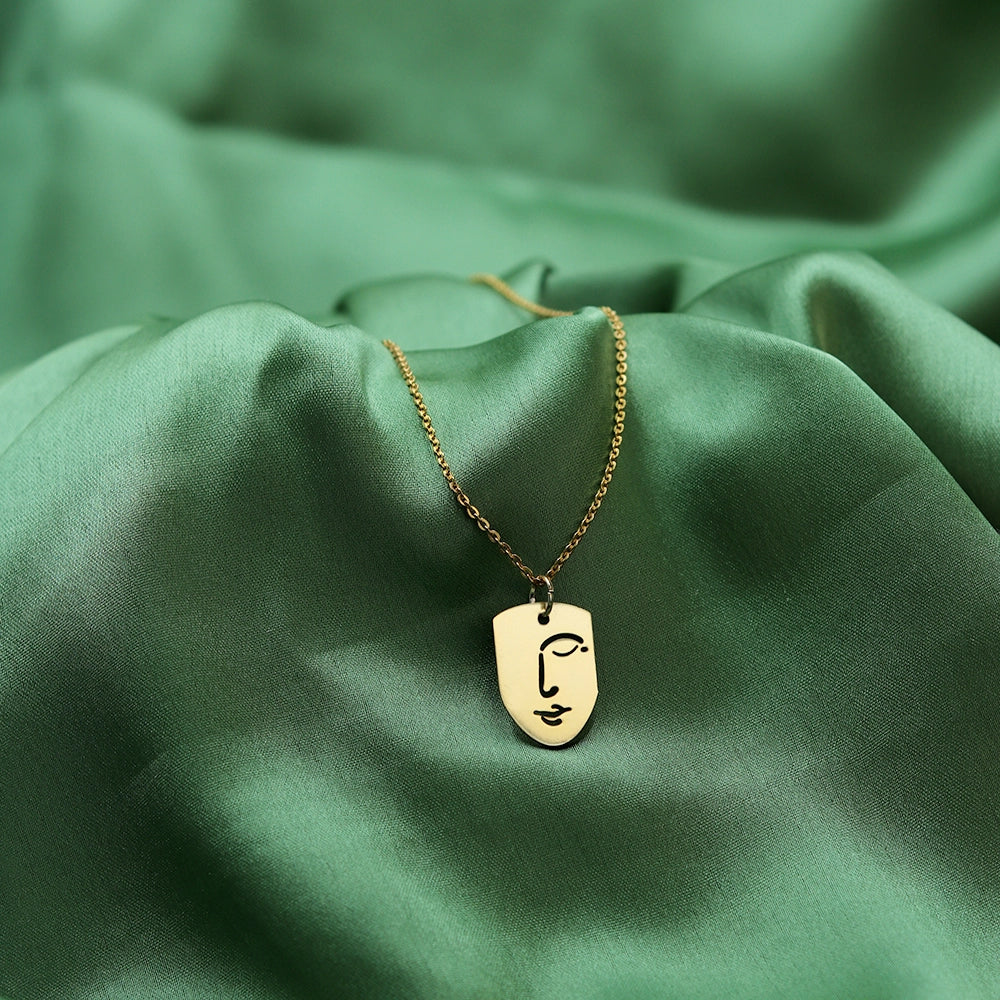 Elevate your style with the Silent Face Necklace. Featuring a sleek, minimalist face pendant, this premium necklace adds a touch of modern elegance to any look. Perfect for everyday wear or special occasions