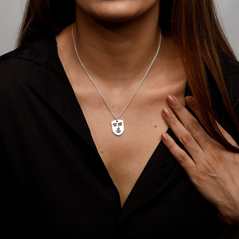 The Face Necklace with modern face-shaped pendant on a sleek chain