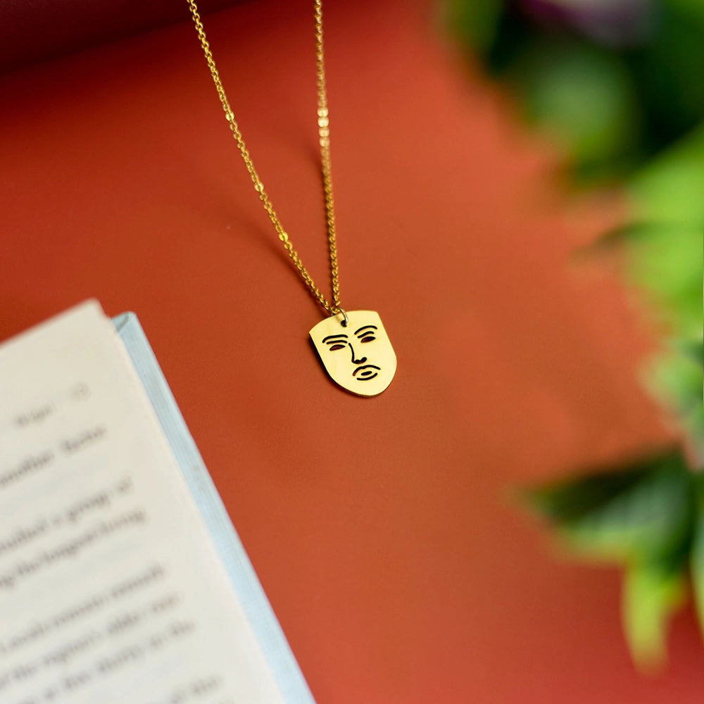 The Face Necklace with modern face-shaped pendant on a sleek chain