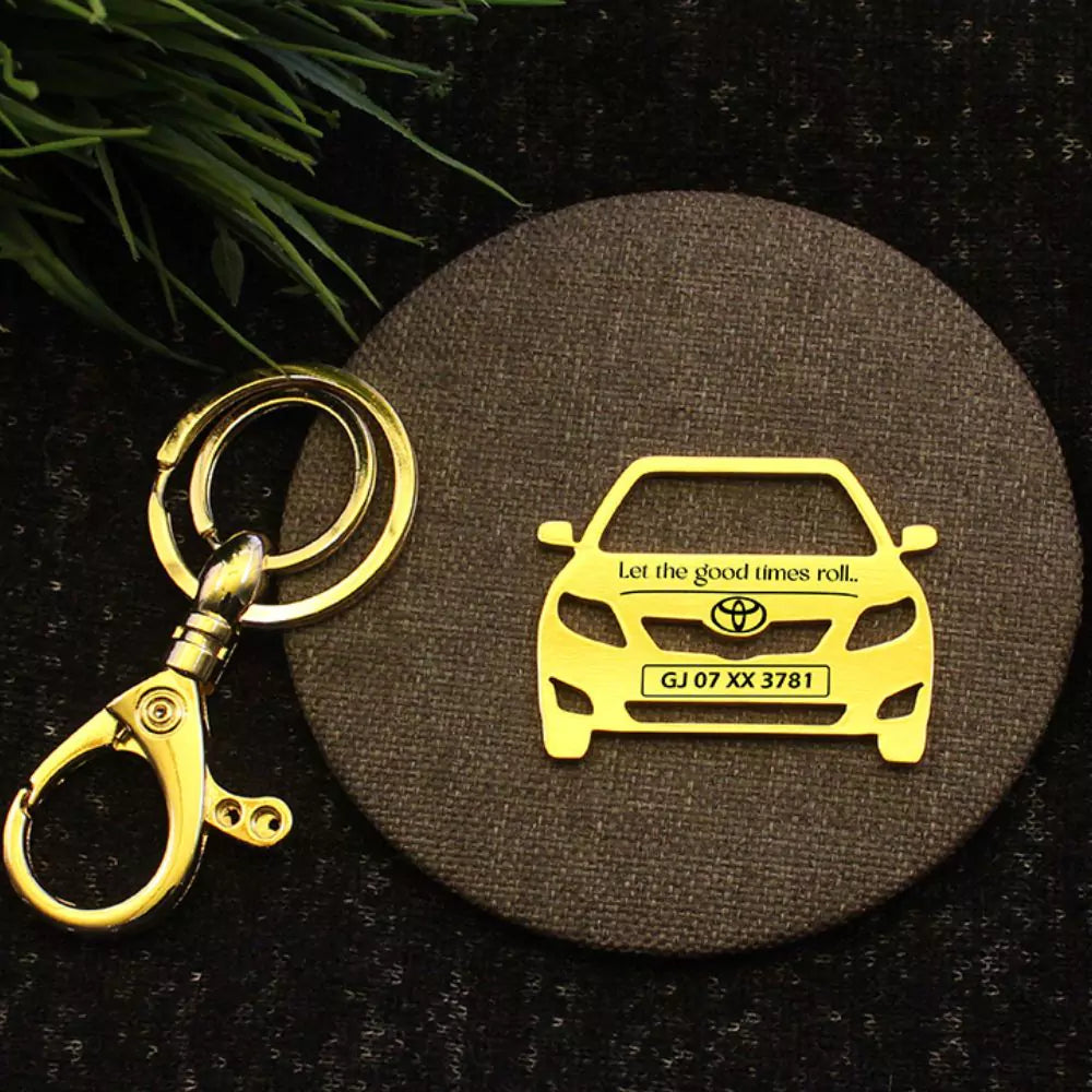 Gold Toyota Corolla keychain engraved with custom name.