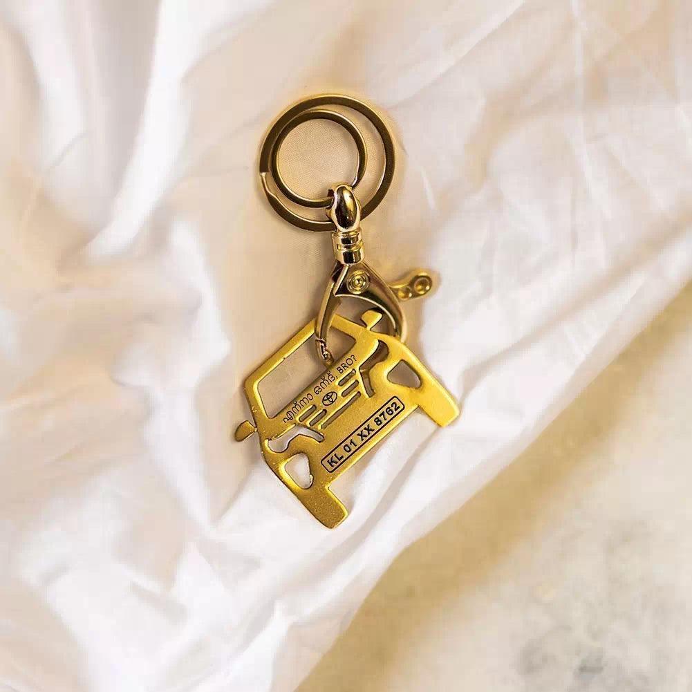 Toyota Fortuner keychain in gold color on black background