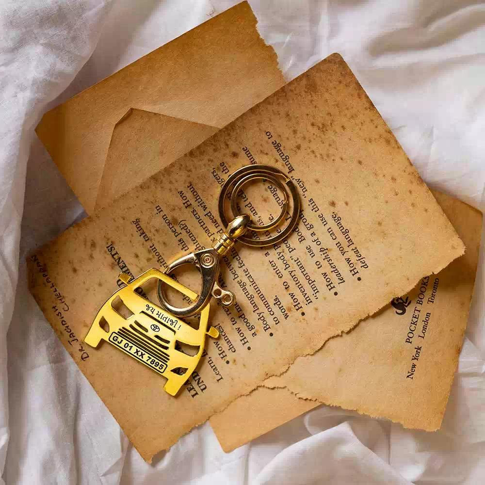 Gold brass Toyota Innova keychain with polished finish, shown on a keyring with car keys